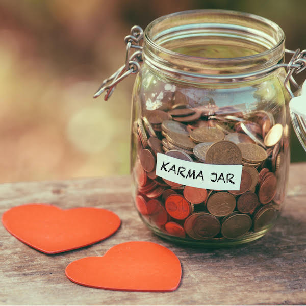 Jar filled with pennies and labeled 'Karma Jar'